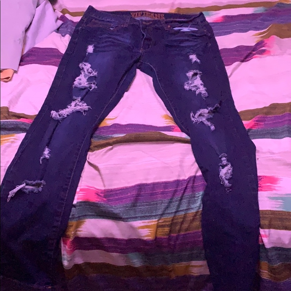 Dark blue straight legged distressed jeans